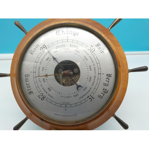 562 - Ships Wheel Weather Master Barometer. 28cm Diameter.