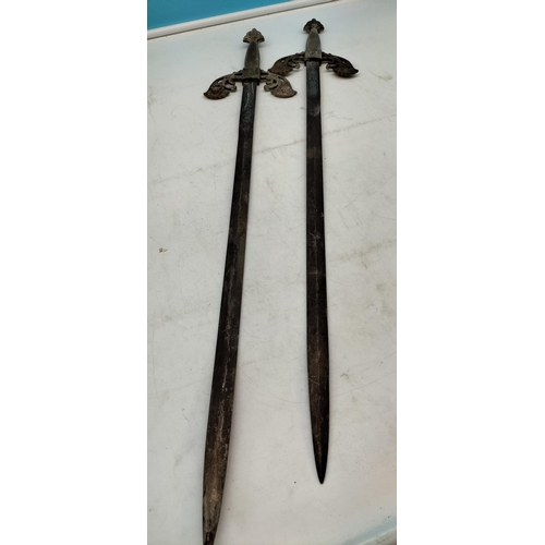 571 - Matching Pair of Medieval Swords plus a Reproduction Brass Handled Sword. Longest 88cm.