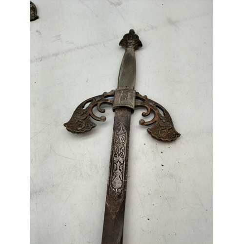 571 - Matching Pair of Medieval Swords plus a Reproduction Brass Handled Sword. Longest 88cm.