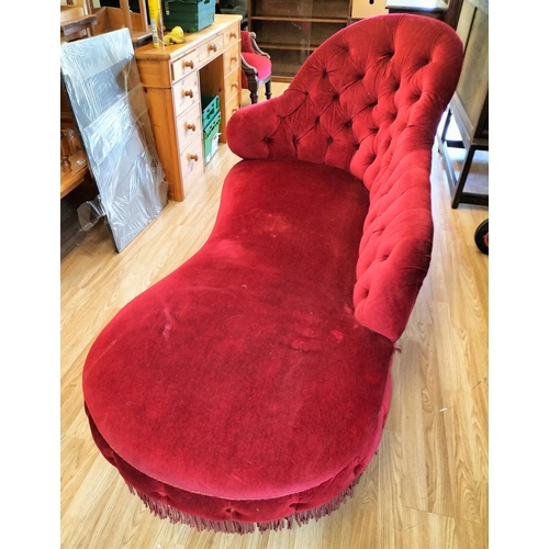 213 - Red Fabric Chaise Longue with Wooden Columned Legs on Castors. One Leg Loose Requires Pinning. lengt... 