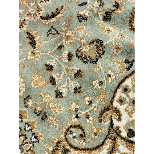 467 - Pale Green Ground Keshan Carpet. 160cm x 230cm.