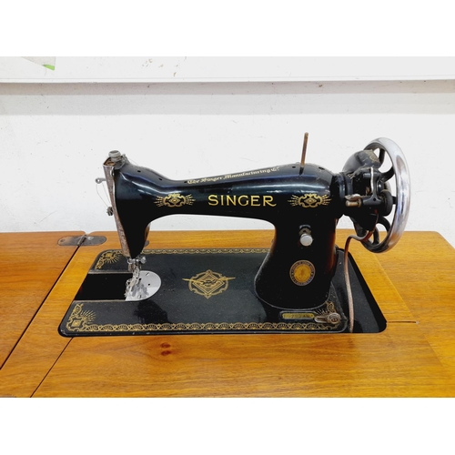 563 - Singer Sewing Machine on Treadle Table. Untested. 118cm x 40cm x 75cm. Collection Only.