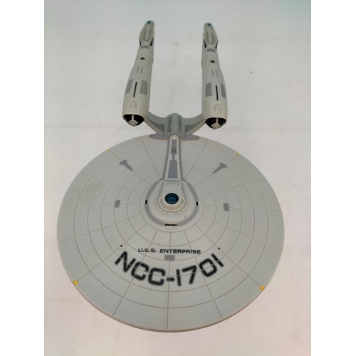 593 - 2009 Playmates Starship USS Enterprise NCC-1701 on Stand. 21cm High, 38cm x 19cm.