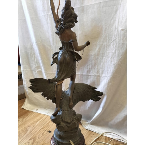 9 - Spelter Figure of a Lady Riding an Eagle Lamp Base on Wooden Stand. 95cm Tall. Collection Only.