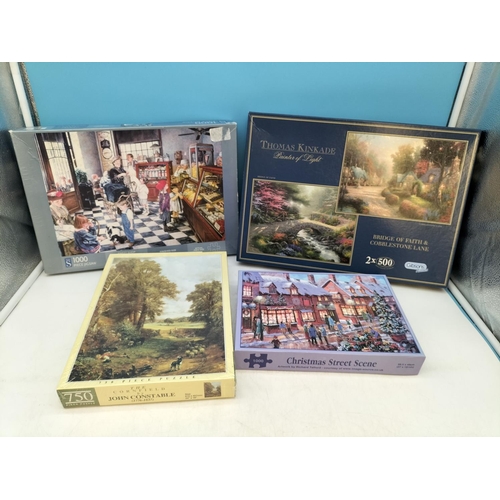 254 - Collection of Jigsaw Puzzles (4) to include a Thomas Kinkade, Christmas Street Scene, The Sweet Shop... 