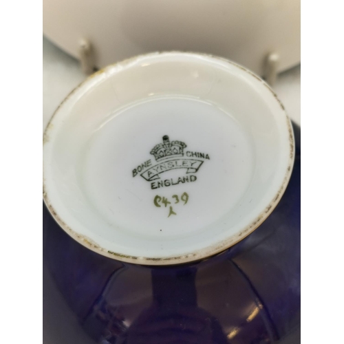 114 - Aynsley Cobalt Blue 'Orchard Gold' Cabinet Cup and Saucer. Signed D Jones.