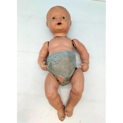 653 - Composite Moulded 1930's Doll. 47cm Long.