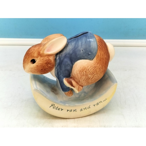 703 - Border Fine Arts Peter Rabbit Money Box A1327. 14cm x 14cm.