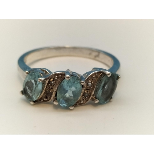 75A - 925 Silver Ring set with 3 Aquamarine and Clear Stones. Size O.