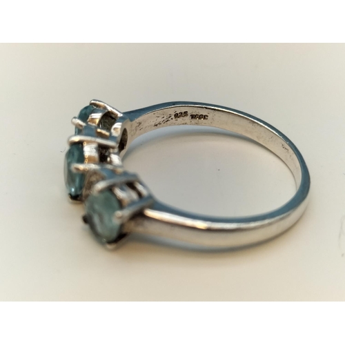 75A - 925 Silver Ring set with 3 Aquamarine and Clear Stones. Size O.