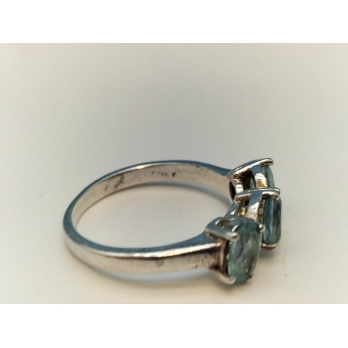 75A - 925 Silver Ring set with 3 Aquamarine and Clear Stones. Size O.