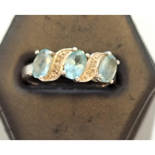 75A - 925 Silver Ring set with 3 Aquamarine and Clear Stones. Size O.