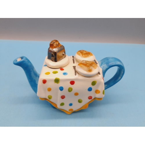 351 - Carters of Suffolk Novelty Teapots (5) to include Racing Car, Golf Bag with Clubs, Artist Table, Bre... 