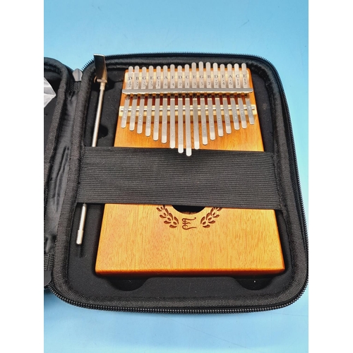 310 - Cased Kalimba Thumb Piano. Model A027. Piano Measures 18cm x 13cm.