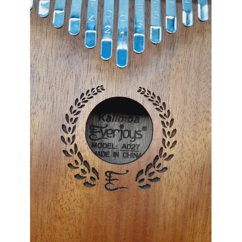 310 - Cased Kalimba Thumb Piano. Model A027. Piano Measures 18cm x 13cm.