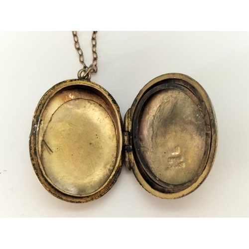 423 - 9ct Gold Front and Back Locket on Yellow Metal Chain.