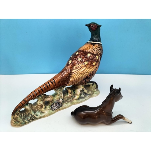 48 - Beswick Figure of a Pheasant 1225 and Laying Foal 915. Tallest 19.5cm.