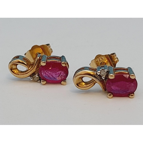 63 - Pair of 9ct 375 Gold, Diamond Chip and Red Stone Earrings. 1.1 Grams.