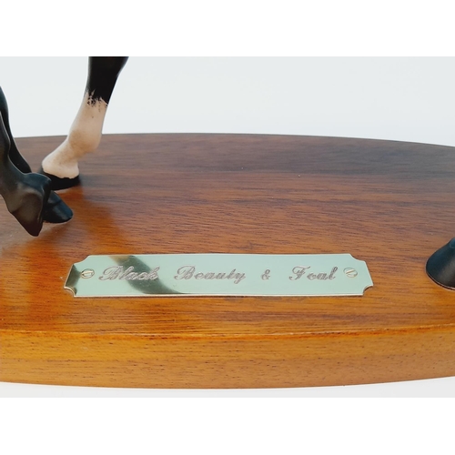 5 - Royal Doulton Figure of Black Beauty and Foal on Wooden Plinth. 20cm High, 30cm x 11cm.