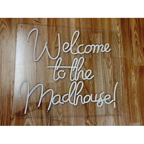 178 - Neon 'Welcome to The Madhouse' Sign with USB Connection W/O. 60cm x 50cm. Small Chip to Plastic.