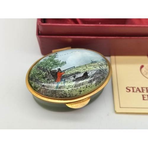 251 - Boxed Staffordshire Enamels Oval Pill Box Decorated with Hunting Scene. 2.5cm high, 5.5cm x 4cm