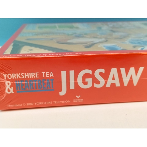 127 - Taylors of Harrogate 'Yorkshire Tea' Tin with Mug, etc plus 2 x Sealed Jigsaws (2) from the Yorkshir... 