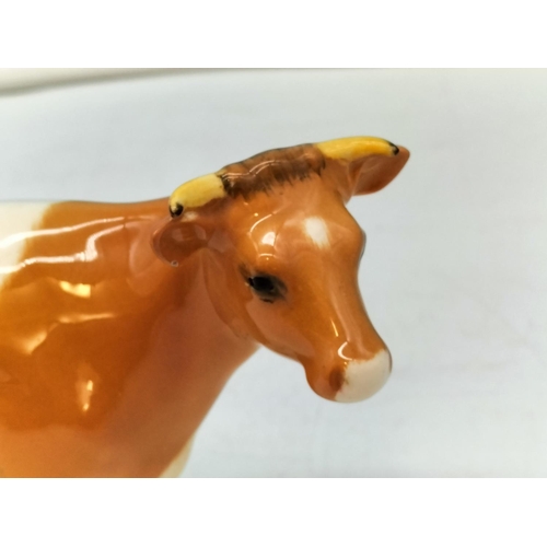 250A - Beswick figure of a Guernsey Cow. Nibble to Ear. 10cm High, 17cm x 5cm.