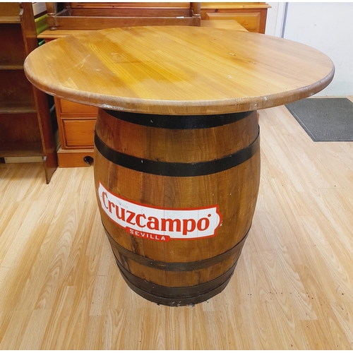 225A - Barrel Table with Cruzcampo Sevilla Advertisment. 87cm High, 91cm Diameter. Collection Only.