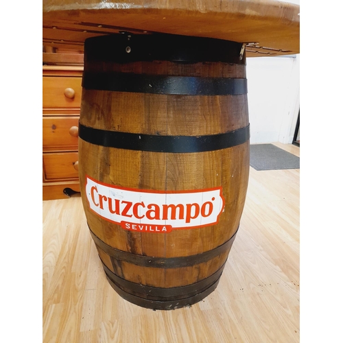 225A - Barrel Table with Cruzcampo Sevilla Advertisment. 87cm High, 91cm Diameter. Collection Only.