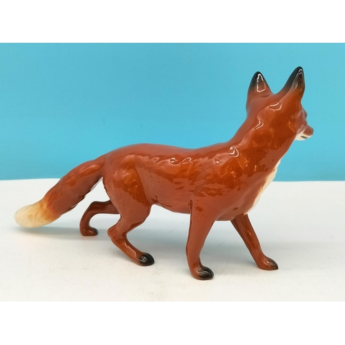 141 - Beswick Figure of a Fox. 14cm High x 24cm.