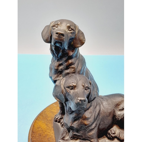 328 - Cold Cast Model of Two Dogs on Plinth. 17cm High, 14cm Diameter.