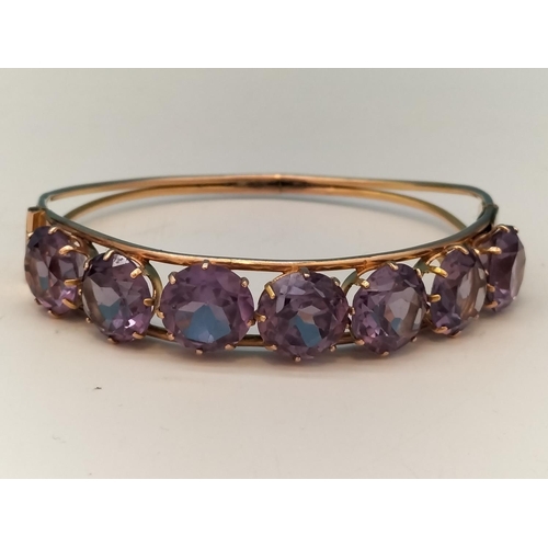 1 - 14ct Gold and Amethyst Bangle. Total Weight 15.5 Grams. With Box.