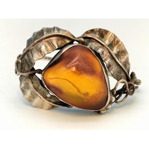 357 - .900 Silver Bangle with Large Natural Amber Centre Stone.