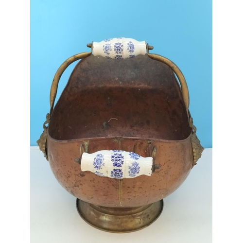 38 - Vintage Copper Helmet Coal Scuttle with Delft Porcelain Handles. 33cm High x 45cm. One Handle A/F.