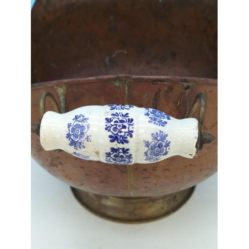 38 - Vintage Copper Helmet Coal Scuttle with Delft Porcelain Handles. 33cm High x 45cm. One Handle A/F.