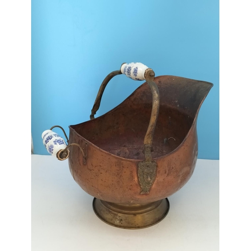 38 - Vintage Copper Helmet Coal Scuttle with Delft Porcelain Handles. 33cm High x 45cm. One Handle A/F.