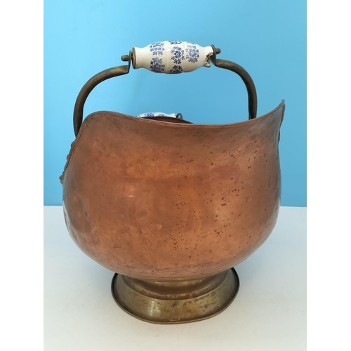 38 - Vintage Copper Helmet Coal Scuttle with Delft Porcelain Handles. 33cm High x 45cm. One Handle A/F.