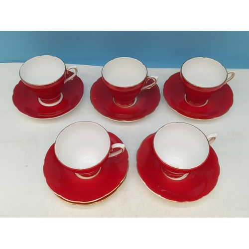 134 - Delphine Bone China Ruby Red Cups (5) and Saucers (6). 1 A/F.