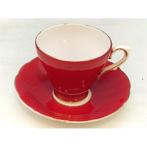 134 - Delphine Bone China Ruby Red Cups (5) and Saucers (6). 1 A/F.