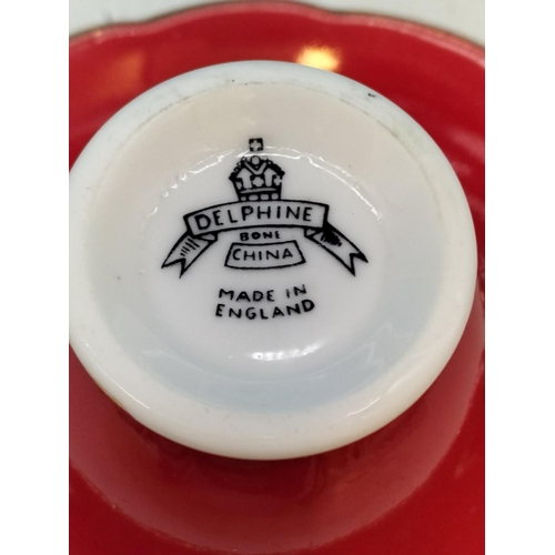 134 - Delphine Bone China Ruby Red Cups (5) and Saucers (6). 1 A/F.