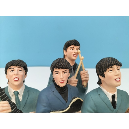 73 - Resin Figure of 'The Beatles'. 13cm High, 20cm x 9cm.