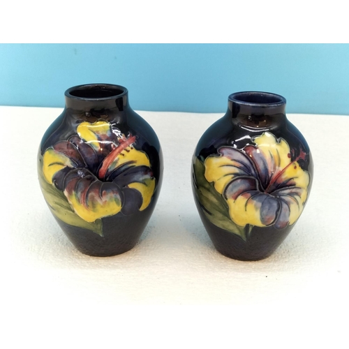 154 - Moorcroft Pottery Hibiscus on Blue Ground Vases (2). Tallest 9cm.