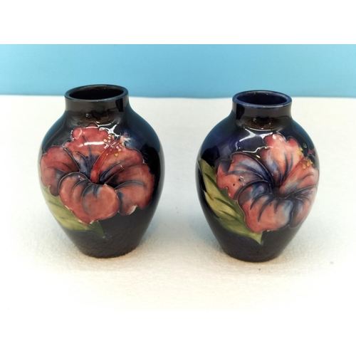 154 - Moorcroft Pottery Hibiscus on Blue Ground Vases (2). Tallest 9cm.
