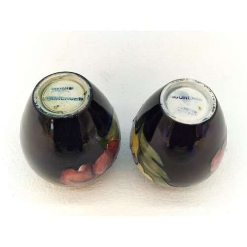 154 - Moorcroft Pottery Hibiscus on Blue Ground Vases (2). Tallest 9cm.