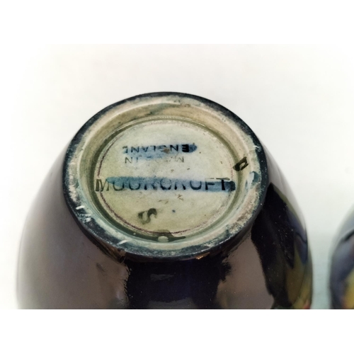 154 - Moorcroft Pottery Hibiscus on Blue Ground Vases (2). Tallest 9cm.