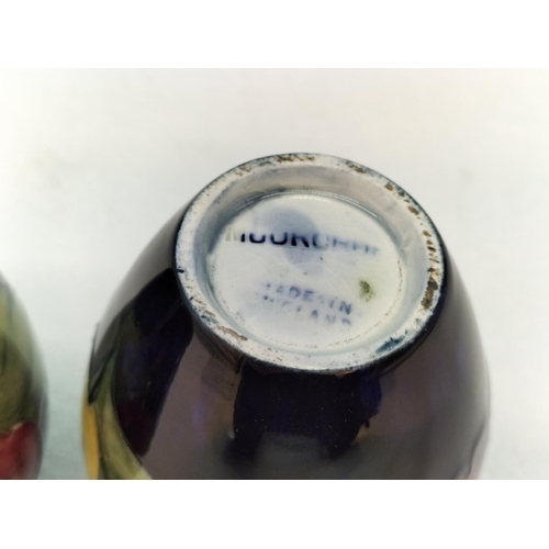 154 - Moorcroft Pottery Hibiscus on Blue Ground Vases (2). Tallest 9cm.