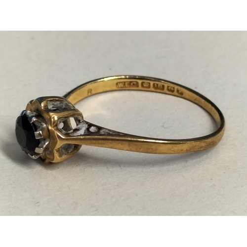 147 - 18ct Gold 750 and Dark Stone Ring. Size M. Total Weight 2.3 Grams.