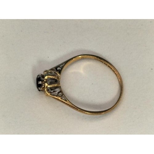 147 - 18ct Gold 750 and Dark Stone Ring. Size M. Total Weight 2.3 Grams.