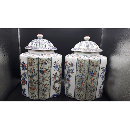 A Pair of Chinese Great Qing Tea jars 14" high with blue 6 character marks. One lid has a repair.