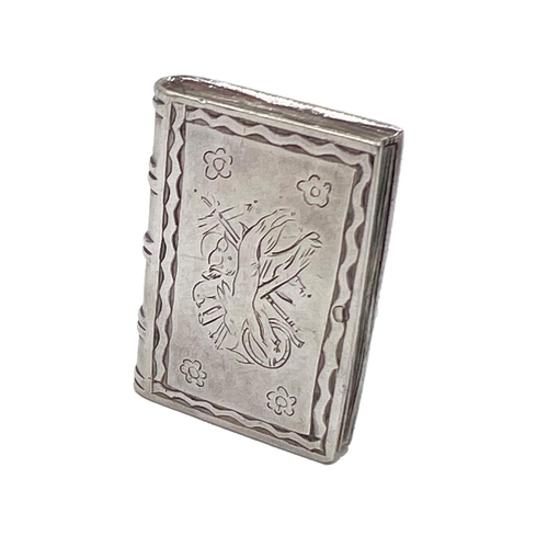 106 - A SILVER BOOK VINAIGRETTE WITH UNUSUAL DECORATION TO FRONT COVER OF MUSICAL INSTRUMENTS, CIRCA 1900A... 